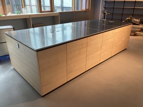 Objekteinrichtung Showkche Vollkernarbeitsplatte, eingefrstes Waschbecken rckseitig verklebt, Mllkipper aus Aluminium, Arbeitsplatte aus Edelstahl mit Kabelausschnitten